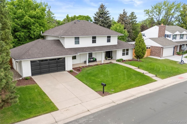 5853 S Havana Ct, Englewood, CO 80111 - view of front of home featuring a shingled roof, covered porch, driveway, and an attached garage