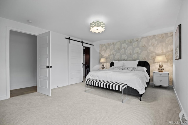 5853 S Havana Ct, Englewood, CO 80111 - bedroom featuring a barn door, carpet floors, baseboards, and wallpapered walls