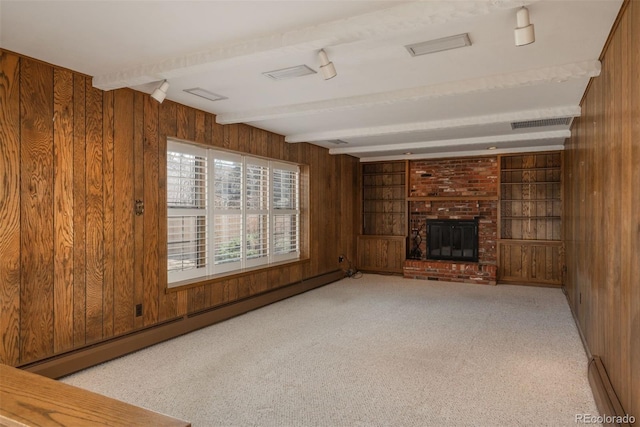 unfurnished living room featuring a baseboard heating unit, carpet, beamed ceiling, and wood walls