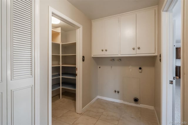 laundry room with baseboards, cabinet space, electric dryer hookup, washer hookup, and hookup for a gas dryer