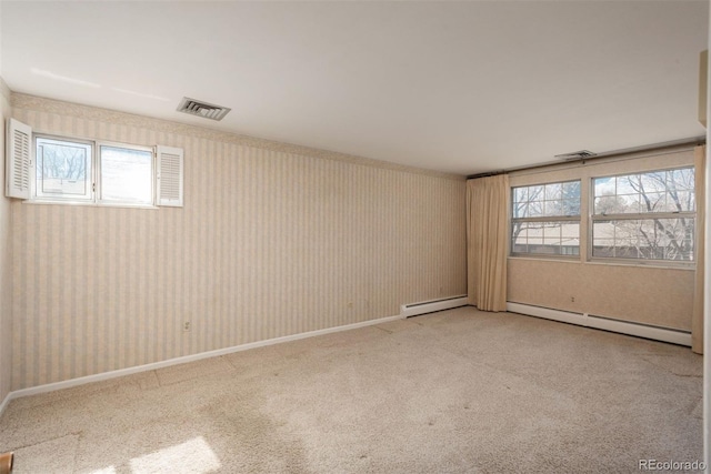 empty room featuring wallpapered walls, baseboards, visible vents, and carpet floors