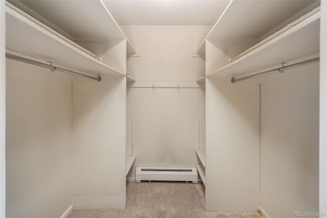 walk in closet with a baseboard heating unit and carpet floors