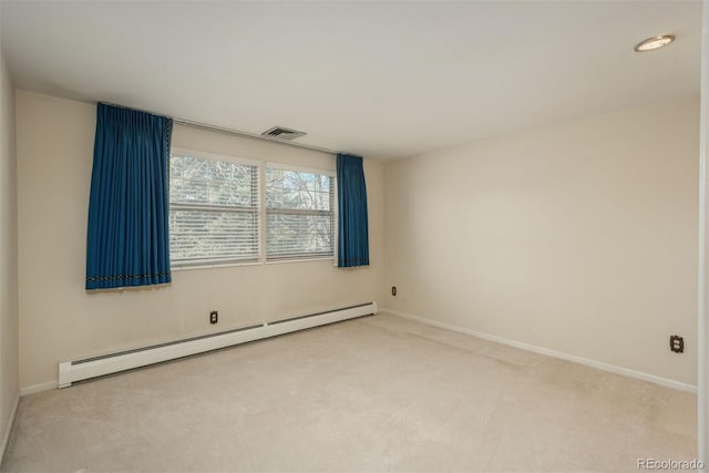 carpeted spare room featuring a baseboard heating unit, baseboards, and visible vents