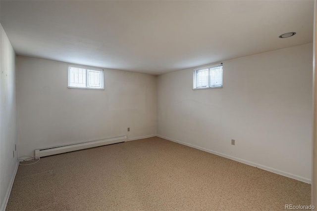 basement with a baseboard heating unit and baseboards