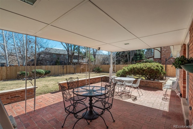 view of patio with outdoor dining space and a fenced backyard