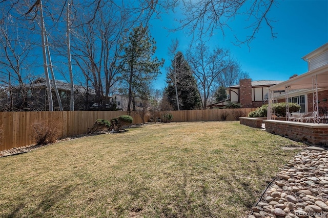 view of yard featuring a patio area and a fenced backyard