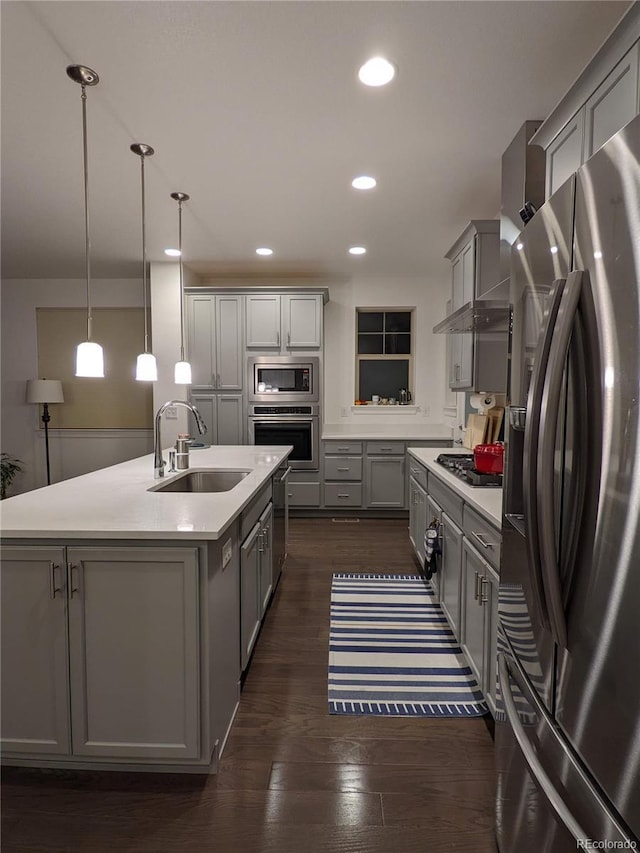 13788 Umatilla Ln, Broomfield, CO 80023 - kitchen with stainless steel appliances, gray cabinets, light countertops, a kitchen island with sink, and recessed lighting