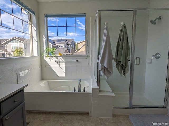 13788 Umatilla Ln, Broomfield, CO 80023 - full bathroom featuring vanity, a bath, and a shower stall