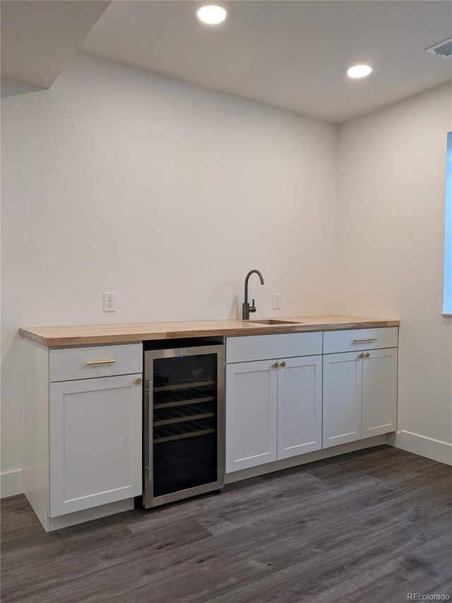 13788 Umatilla Ln, Broomfield, CO 80023 - indoor wet bar with wine cooler, dark wood-style flooring, and recessed lighting