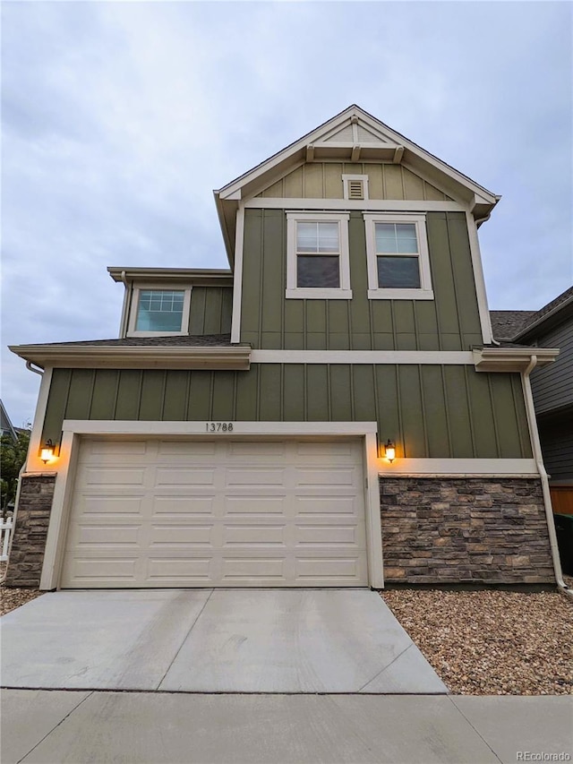 13788 Umatilla Ln, Broomfield, CO 80023 - view of front of property featuring stone siding, board and batten siding, concrete driveway, and an attached garage