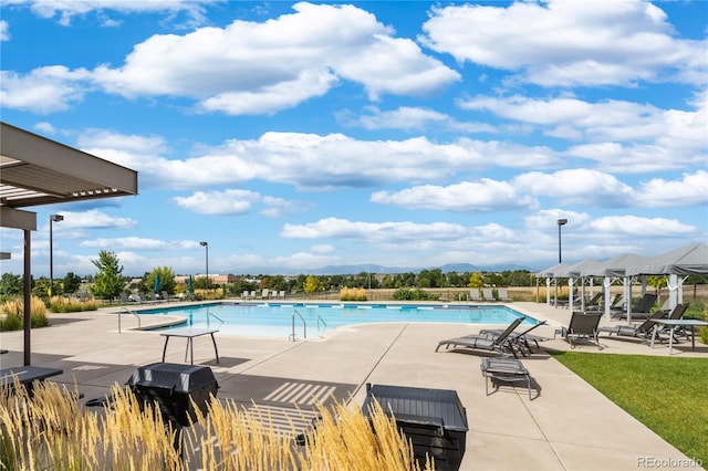 13788 Umatilla Ln, Broomfield, CO 80023 - community pool featuring a patio area, a mountain view, and area for grilling