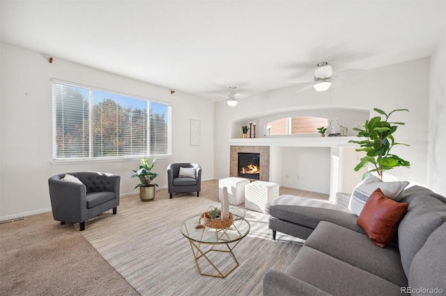 carpeted living room featuring plenty of natural light and ceiling fan