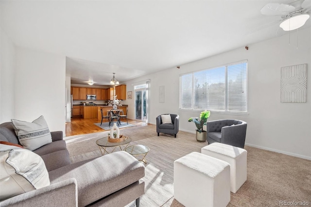 living room with light carpet and ceiling fan