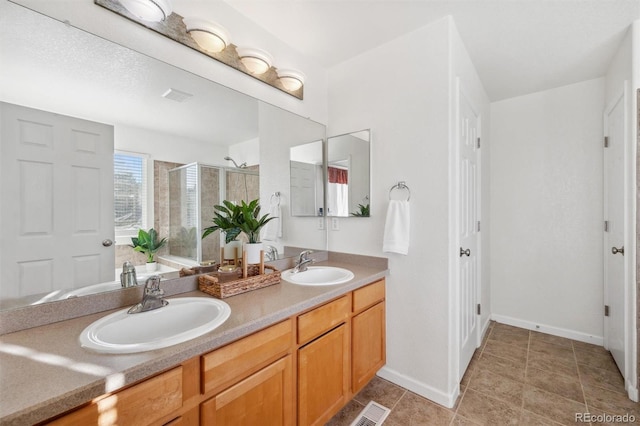 bathroom with vanity, tile patterned flooring, and walk in shower