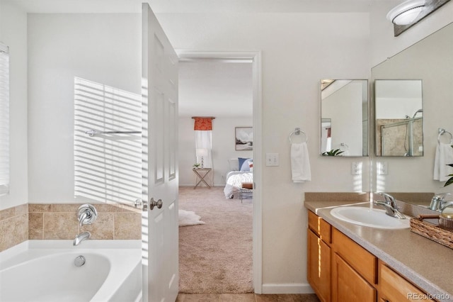 bathroom with vanity and a washtub