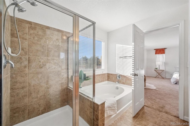 bathroom featuring a textured ceiling, plus walk in shower, and tile patterned flooring