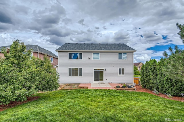 back of house featuring a patio and a yard