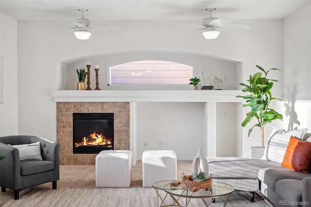 living room with ceiling fan and a fireplace