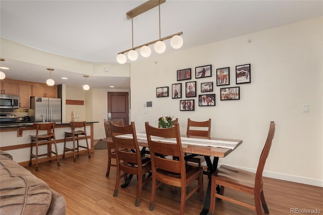 dining space with light wood-type flooring