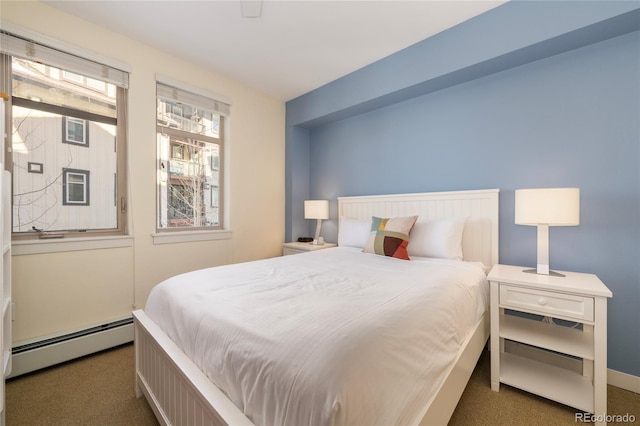 carpeted bedroom featuring baseboard heating