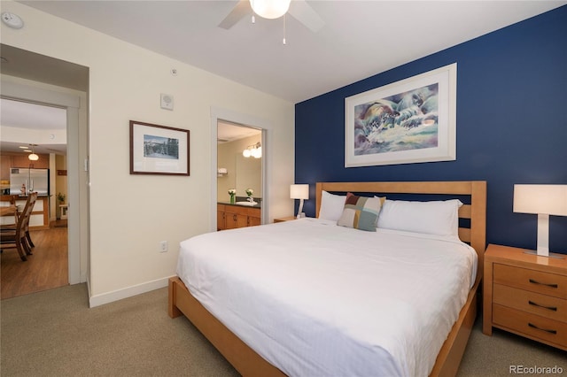 carpeted bedroom with ceiling fan, stainless steel fridge, and connected bathroom