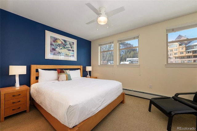 bedroom with ceiling fan, light colored carpet, and a baseboard heating unit