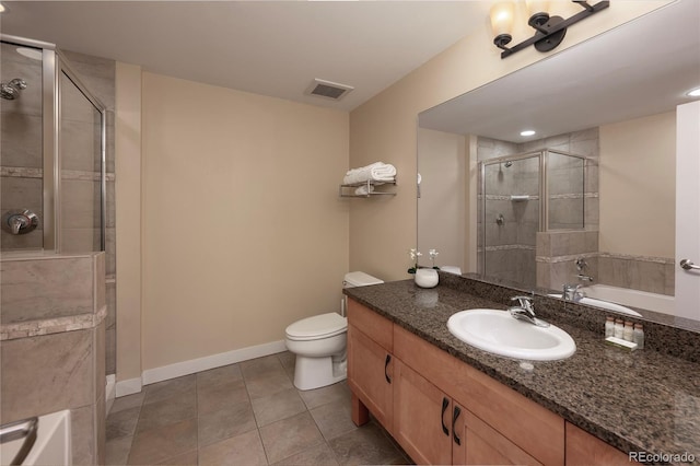 bathroom featuring tile patterned floors, toilet, vanity, and walk in shower