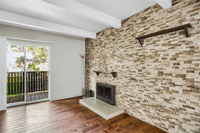 9995 E Harvard Ave Unit 290, Denver, CO 80231 - unfurnished living room featuring beam ceiling, wood finished floors, and a tiled fireplace