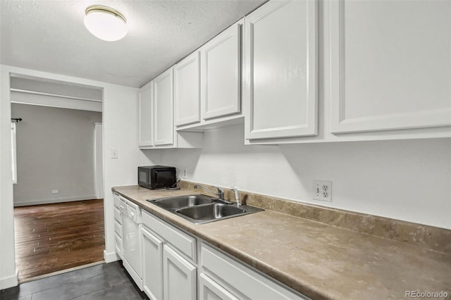 9995 E Harvard Ave Unit 290, Denver, CO 80231 - kitchen featuring a sink, white cabinets, black microwave, a textured ceiling, and light countertops