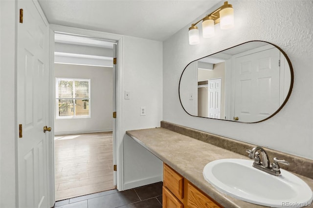 9995 E Harvard Ave Unit 290, Denver, CO 80231 - bathroom with vanity, tile patterned flooring, and baseboards