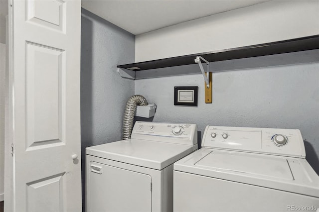 9995 E Harvard Ave Unit 290, Denver, CO 80231 - washroom with a textured wall and washer and dryer