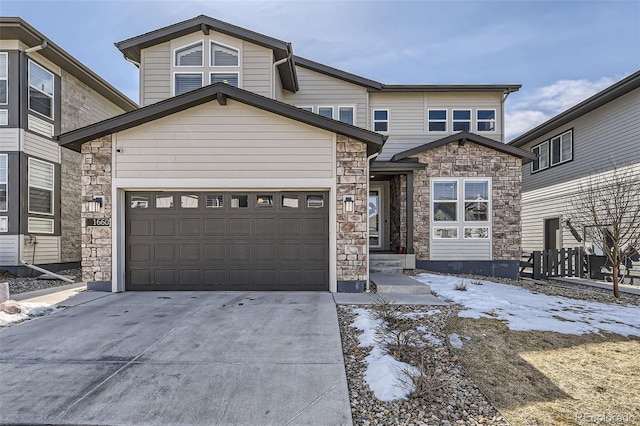 view of front of property with stone siding, driveway, and a garage