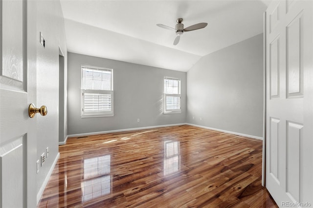 unfurnished bedroom with hardwood / wood-style floors, ceiling fan, and vaulted ceiling