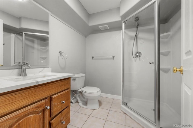 bathroom featuring tile patterned flooring, vanity, toilet, and walk in shower