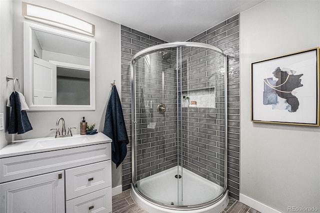8712 W 64th Way, Arvada, CO 80004 - full bathroom featuring a shower stall, baseboards, and vanity