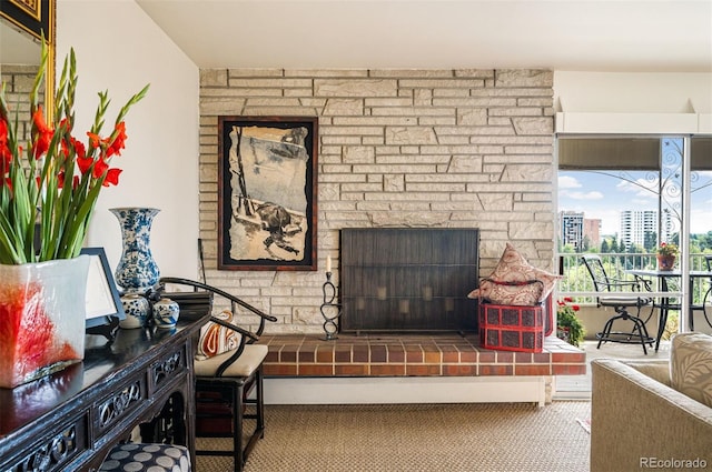 living area featuring a city view and a fireplace