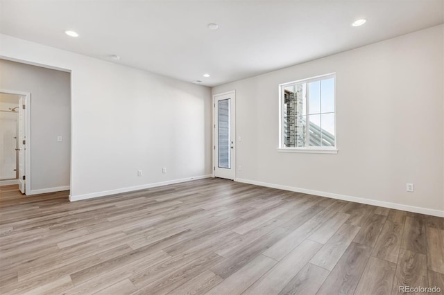 spare room featuring light wood-type flooring