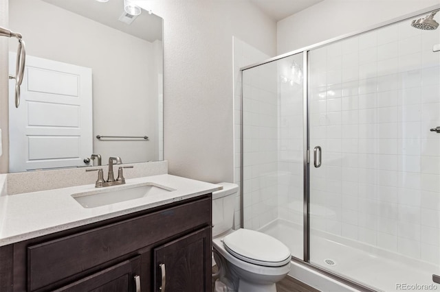 bathroom with vanity, toilet, and walk in shower