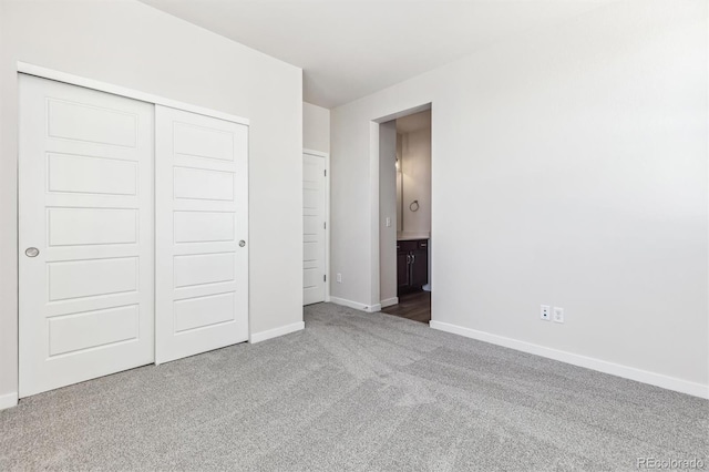 unfurnished bedroom featuring carpet and a closet