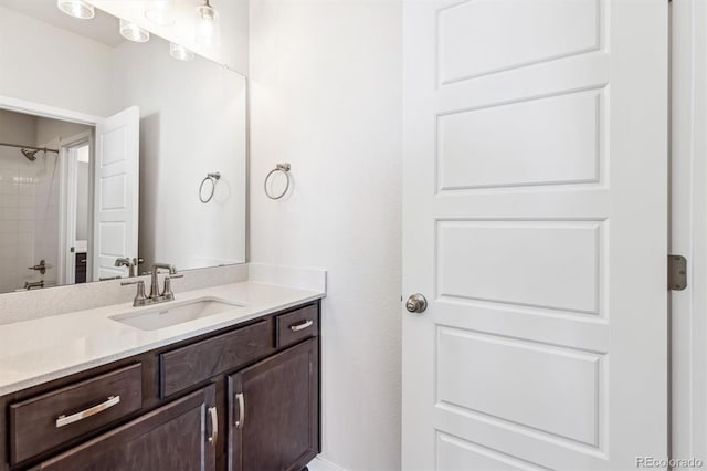 bathroom featuring vanity and tiled shower