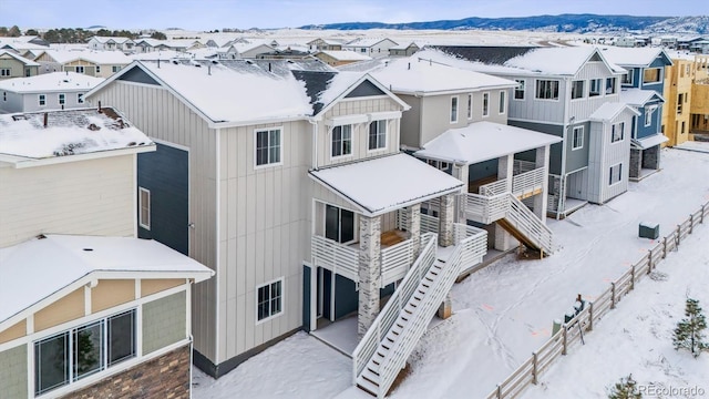 snowy aerial view with a mountain view