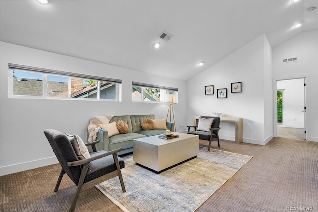 carpeted living room featuring high vaulted ceiling