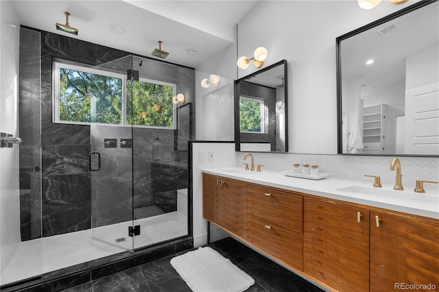 bathroom featuring backsplash, vanity, and a shower with shower door