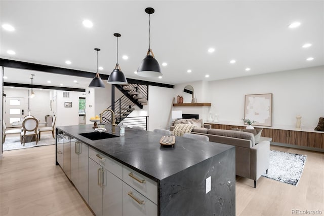 863 S Race St, Denver, CO 80209 - kitchen featuring dark countertops, a fireplace, a large island, light wood-style floors, and recessed lighting