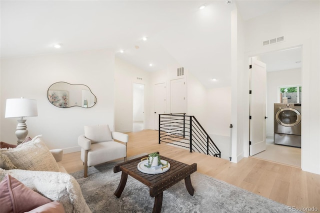 863 S Race St, Denver, CO 80209 - living room with washer / dryer, wood finished floors, and lofted ceiling