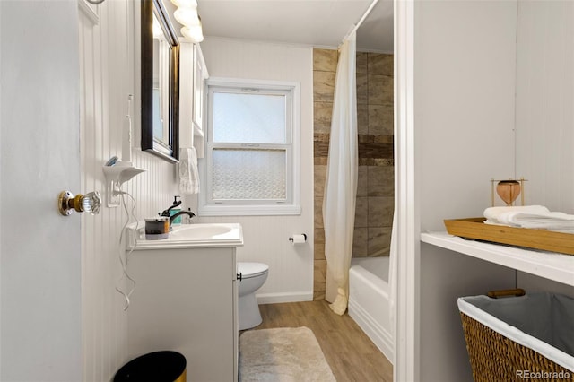 full bathroom featuring toilet, shower / tub combo, vanity, and hardwood / wood-style floors