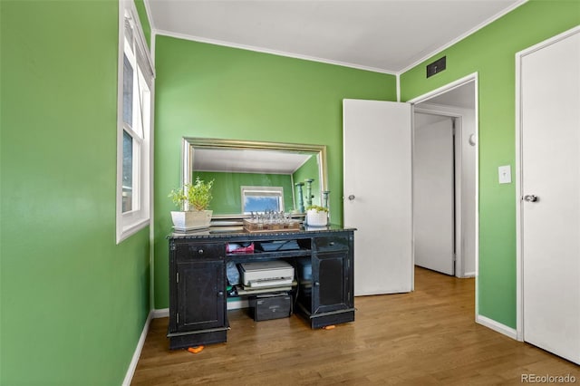 bathroom featuring crown molding and hardwood / wood-style flooring