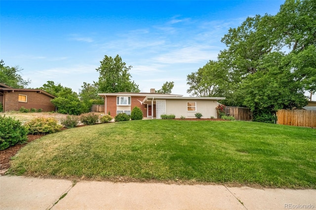 8051 S Kendall Blvd, Littleton, CO 80128 - view of front of home with a chimney and brick siding