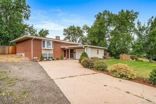 8051 S Kendall Blvd, Littleton, CO 80128 - view of front of house featuring brick siding, a garage, concrete driveway, and a chimney