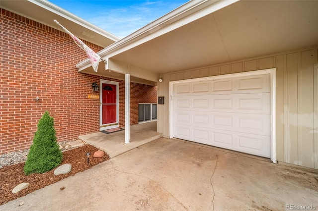 8051 S Kendall Blvd, Littleton, CO 80128 - doorway to property featuring driveway, brick siding, and a garage